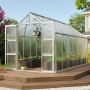 Vitavia Gewächshaus Olymp 11500 aus Alu mit Fundamentrahmen, auf einer Holzterrasse vor einem Haus.