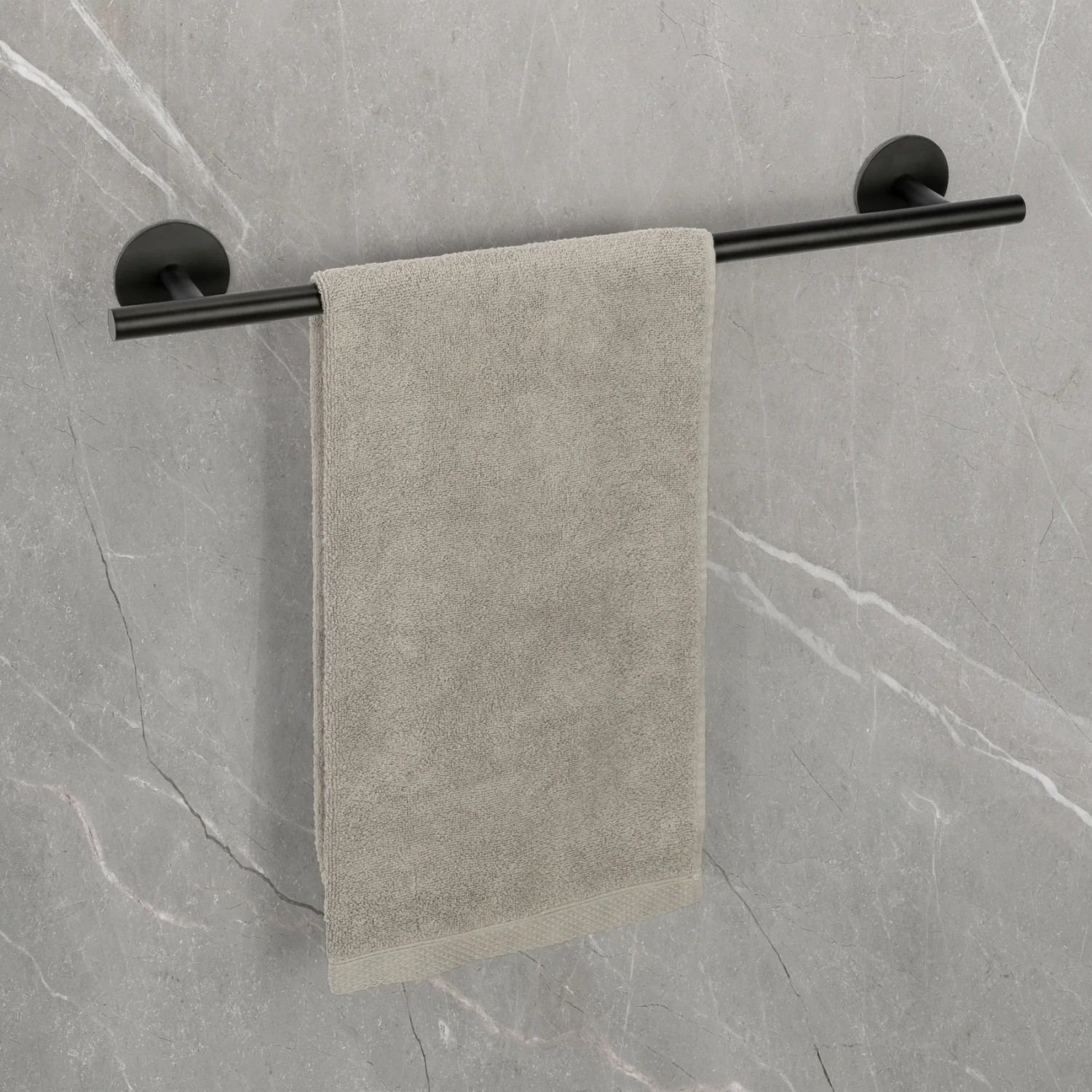 Schwarze Schöner Wohnen Badetuchstange Uno Meleto (60 cm) mit Handtuch an grauer Wand.