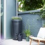 Schwarze Elho Regentonne Green-Basics 200L mit integriertem Pflanzkasten im Garten.