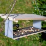 Dobar Vogelfutterhaus Futura II mit Vogel beim Fressen. Modernes Design mit Holz und Metall.