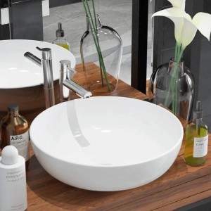 Rundes weißes Keramik-Aufsatzwaschbecken auf Holzwaschtisch im modernen Badezimmer. Glänzende Oberfläche, stilvolles Design.