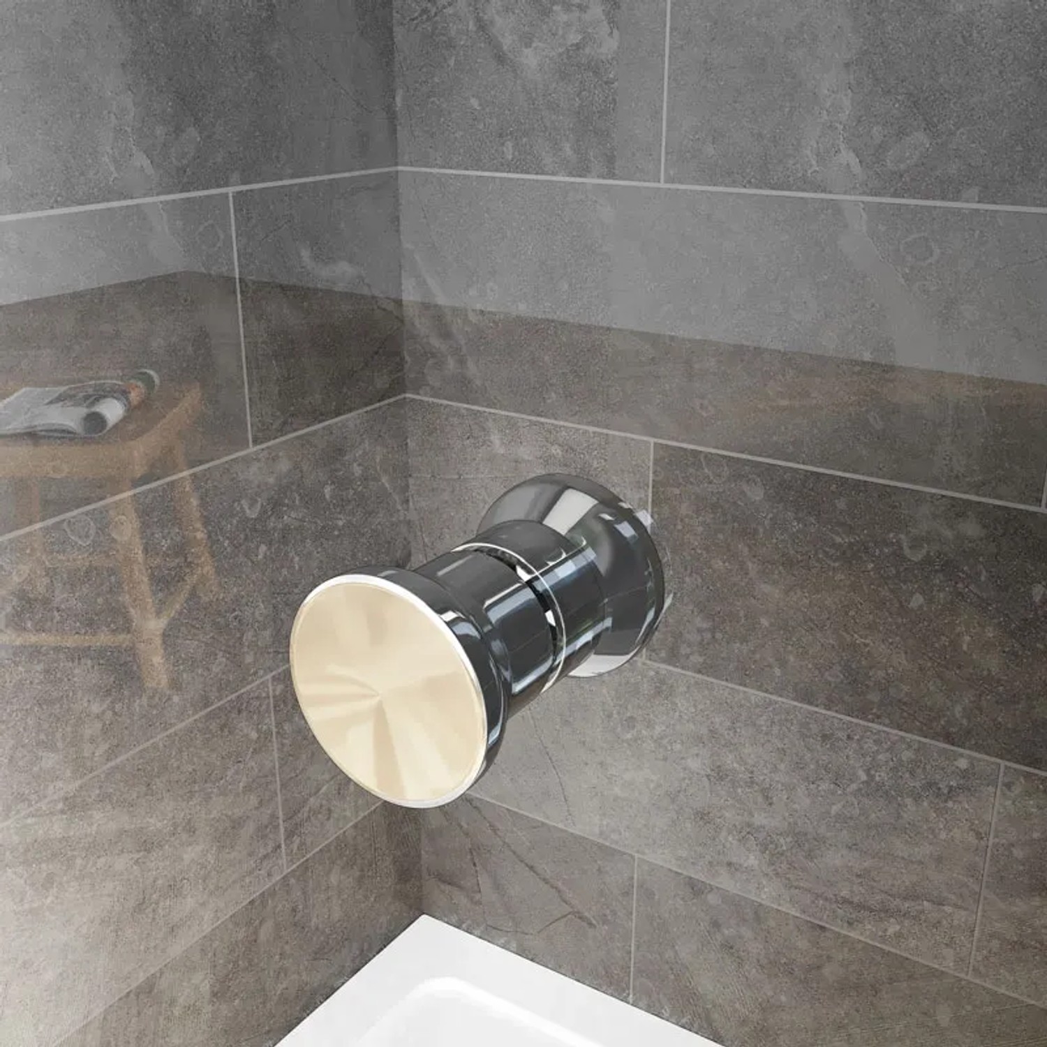 Detailaufnahme: Chromfarbener Duschkopf an grauer Wand im Badezimmer.
