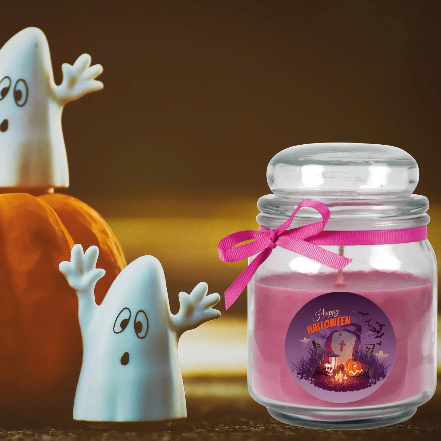 Lila Halloween Duftkerze im Glas (70h) mit Geister-Deko für stimmungsvolle Herbstabende.
