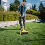 Mann nutzt Gloria MultiBrush XL Elektro-Oberflächenbürste im Garten zur Rasenpflege.