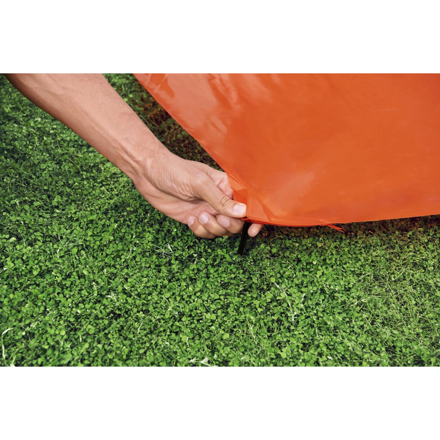 Detailaufnahme: Hand befestigt Bestway H2OGO! Wasserrutsche am Boden.