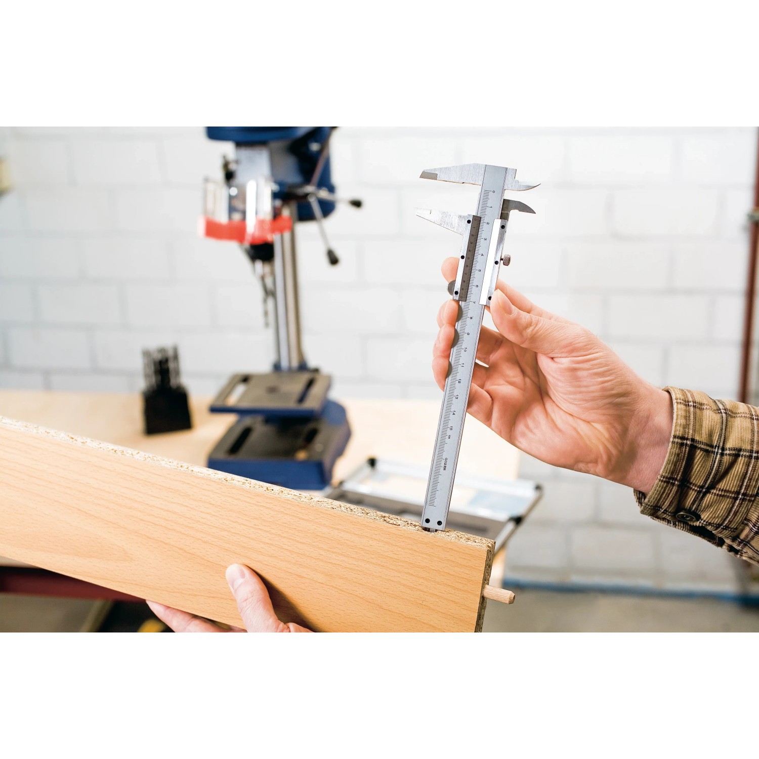 LUX Schieblehre Comfort 150 mm beim Messen eines Holzstücks. Präzises Messwerkzeug für Handwerker.