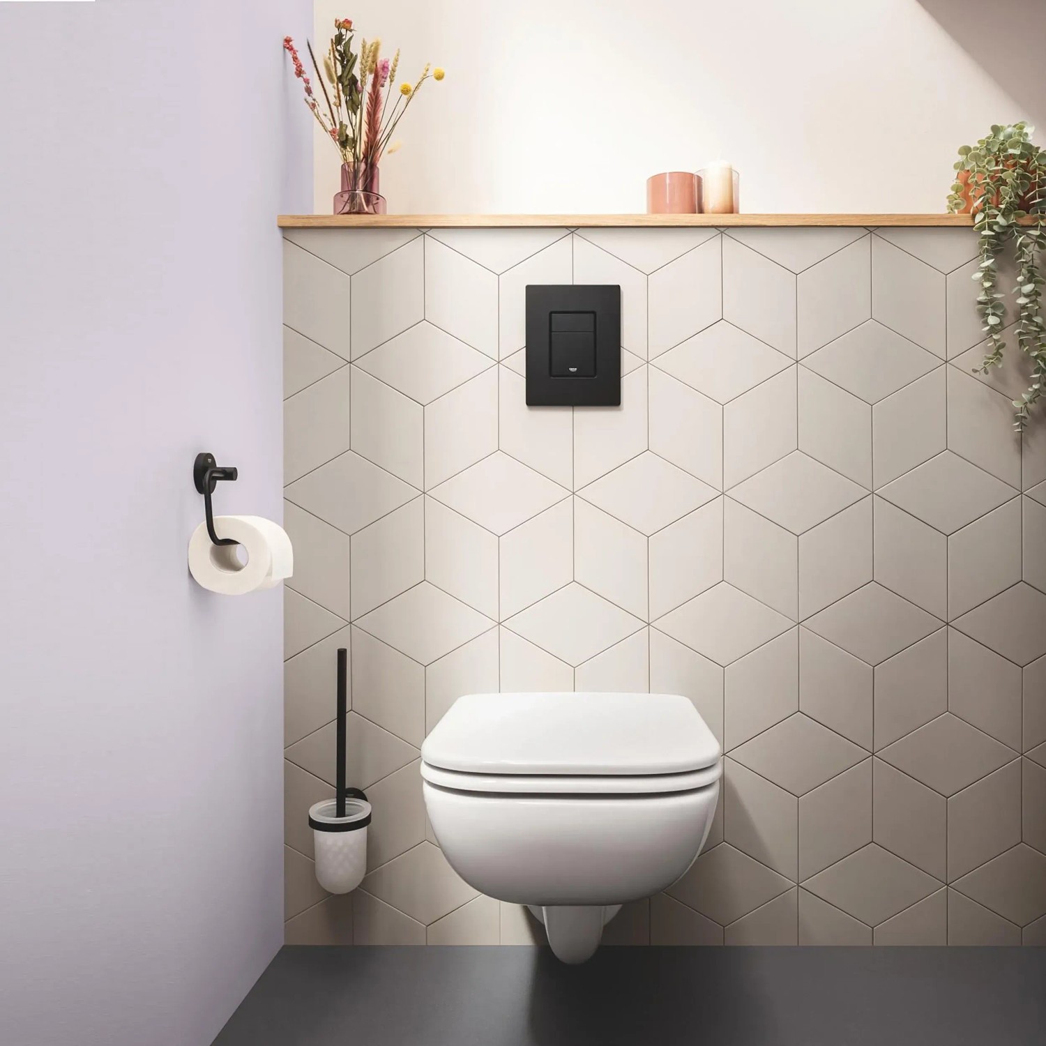 Grohe Even WC-Drückerplatte in Mattschwarz an Wand über einem Hänge-WC.