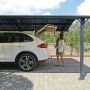 Canopia Carport Arcadia 5000 in Anthrazit mit Auto und Frau beim Ausladen. PKW Unterstand mit Dach.