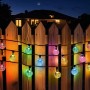 Bunte Solar LED Lichterkette mit 40 Kristalllampen am Holzzaun bei Nacht. Ideal für Garten & Weihnachtsbeleuchtung.