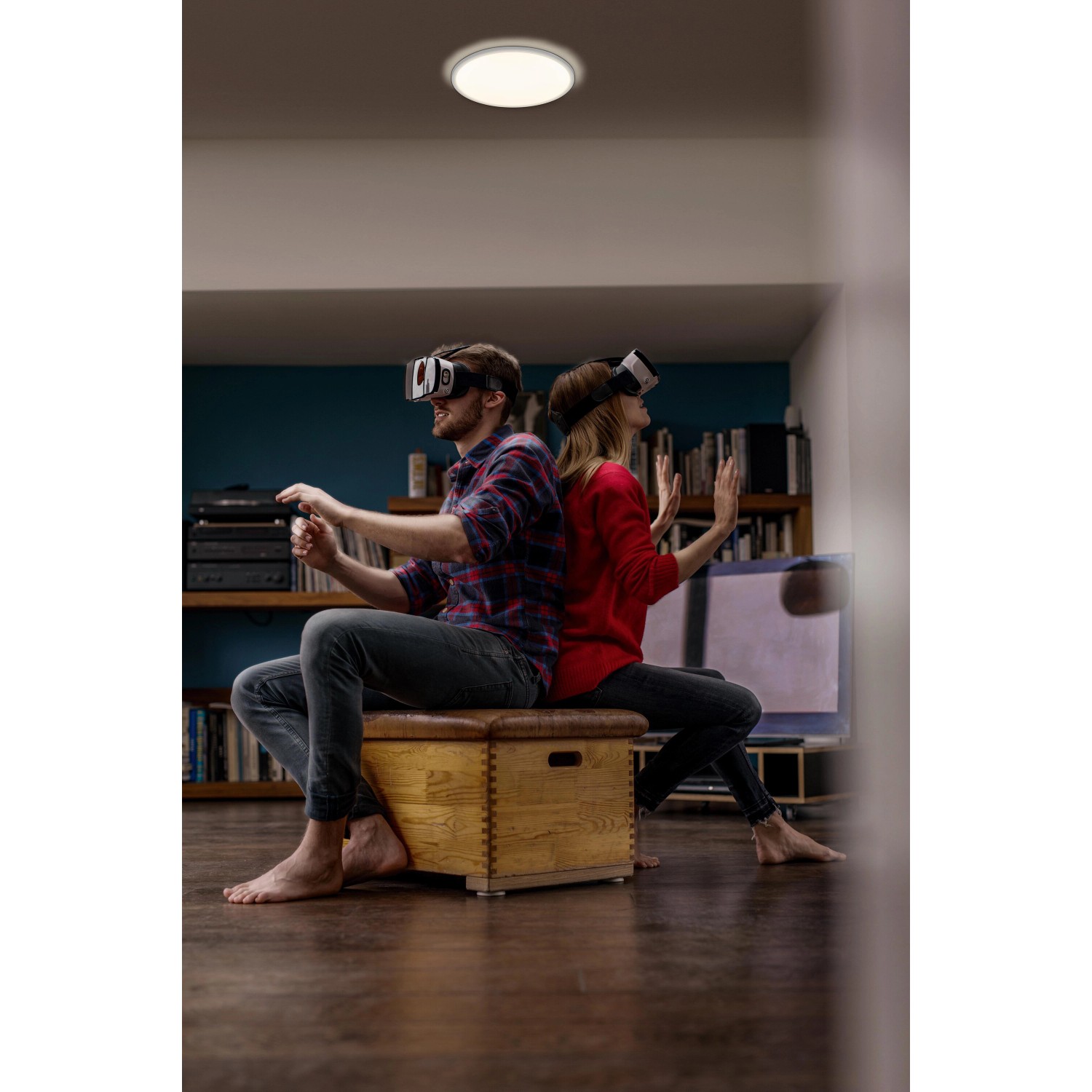 Ledvance Smart+ LED-Deckenleuchte Orbis Ultra Slim in Schwarz, montiert in Wohnraum mit zwei Personen.