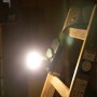 REV Ritter LED-Steckdosenstrahler (10W, dimmbar) an einer Holzleiter.