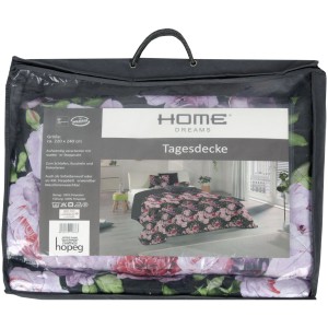 Bestlivings Tagesdecke Lilia mit Blumenmuster, verpackt in einer Tragetasche.
