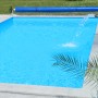 Rechteckiger, blauer Styropor Pool-Set Classic de Luxe mit Poolabdeckung und Wasserfall im Garten.