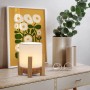 Näve LED-Akkutischleuchte Madita mit Holzfuß und weißem Schirm als Stimmungslicht.