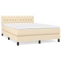 Cremefarbenes Boxspringbett 140x190 cm mit Stoffbezug und gestepptem Kopfteil.