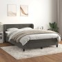 Dunkelgraues Boxspringbett (140x190 cm) mit Matratze und Samtbezug im Schlafzimmer.