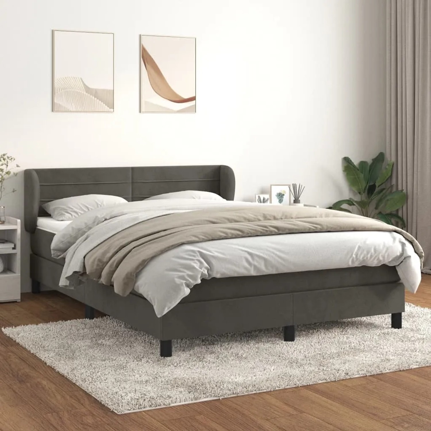 Dunkelgraues Boxspringbett (140x190 cm) mit Matratze und Samtbezug im Schlafzimmer.