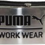 Schwarzer Puma Workwear Koppelgürtel mit Metallschnalle und Logo.