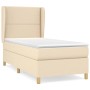 Cremefarbenes Boxspringbett 100x200 cm mit Matratze und Kopfteil aus Stoff.