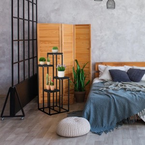 Schwarze Relaxdays Blumentreppe aus Stahl/MDF mit 4 Ablagen im Schlafzimmer mit Pflanzen dekoriert.