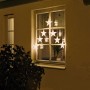 Konstsmide LED-Lichtervorhang mit 7 Sternen und warmweißen LEDs am Fenster.
