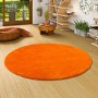 Runder, orangefarbener Snapstyle Hochflor Shaggy Teppich Palace, 160x160cm, im Wohnraum.