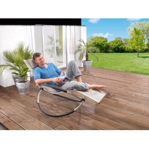 Mann entspannt auf Leco Schaukelstuhl (Schwarz/Beige/Silber) im Garten. Bequeme Sonnenliege mit Schaukelfunktion.
