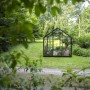 Schwarzes Halls Gewächshaus Popular 6,2 m² im Garten, ideal für Pflanzenzucht.