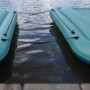 Zwei verbundene, türkisfarbene Bestway Hydro Force Floating Platforms auf dem Wasser.