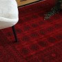 RugsX Orient-Teppich rot mit klassischem Muster und Fransen im Wohnzimmer, unter weißem Sessel.