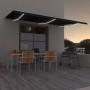 Anthrazitfarbene, automatische vidaXL Markise mit LED und Windsensor (600x300 cm) über einer Terrasse.