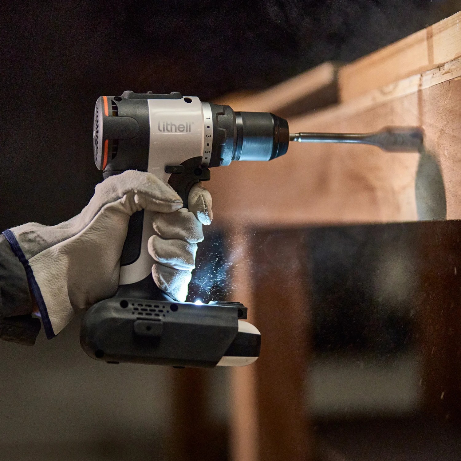 Litheli Akku-Bohrer beim Bohren in Holz, mit LED-Licht und Handschuh.