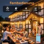 Salcar Solar Eiszapfen-Lichterkette warmweiß am Haus, Familie feiert im Garten. Fernbedienung mit 13 Modi.