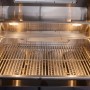 Detailaufnahme des geöffneten Grills der Buschbeck Outdoorküche Liverpool Schwarz mit Edelstahl-Grillrost.