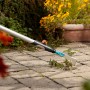 Gardena Combisystem Fugenkratzer im Einsatz zum Entfernen von Unkraut zwischen Pflastersteinen.