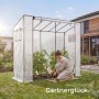 Transparentes Tectake Foliengewächshaus Anton im Garten. Eine Person pflegt Tomatenpflanzen. Wetterfest & UV-beständig.