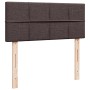 Boxspringbett Kopfteil in Dunkelbraun mit Stoffbezug und Holzfüßen.