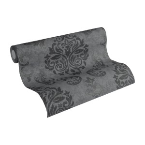 Livingwalls Vliestapete mit Barockmuster in Schwarz, Silber und Grau auf Rolle.
