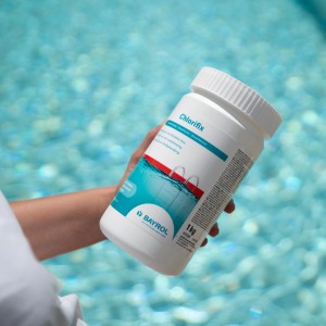 Bayrol Chlorifix 5 kg, Chlorgranulat zur Pool Desinfektion in weißer Dose vor Poolwasser.