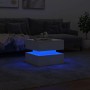 Weißer Couchtisch mit blauen LED-Leuchten im modernen Wohnzimmer. 50x50x40 cm.