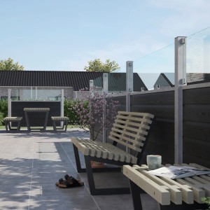 Moderner Sichtschutzzaun Artura in Schiefergrau mit Glaselementen, kombiniert mit Gartenmöbeln.