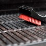 Char-Broil Grillbürste Cool Clean Premium bei der Reinigung eines Grillrosts.