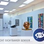 LED-Panel Alegre in Galerie: Flaches, weißes Design mit unsichtbarem Sensor in moderner Umgebung.