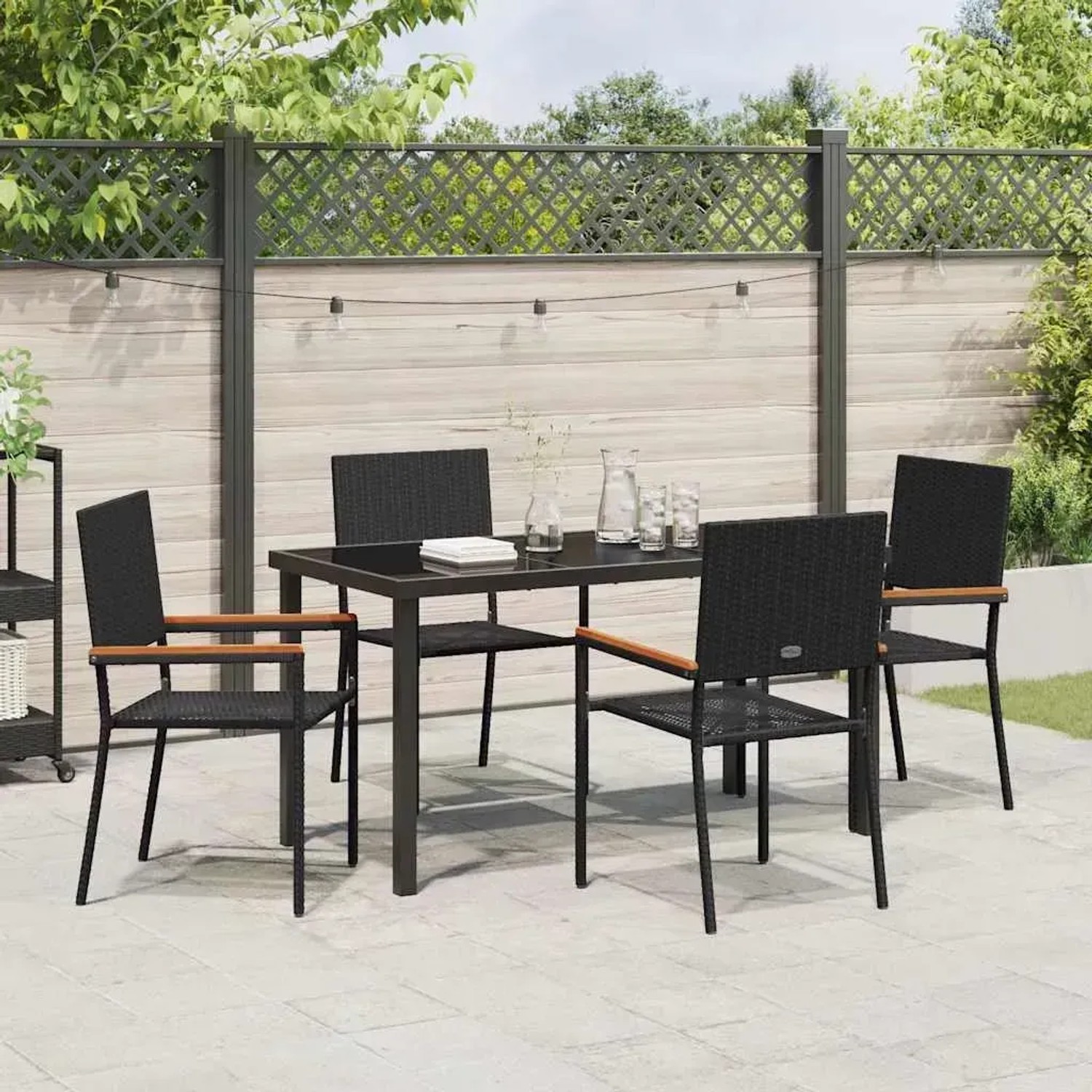Schwarze 5-tlg. vidaXL Garten Essgruppe aus Poly Rattan mit Tisch und vier Stühlen.