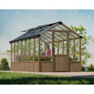 CANOPIA Gewächshaus Natura Braun 12m² mit Fundamentrahmen und Frau beim Gärtnern.