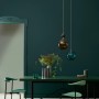 Raum in Botanical Noir No. 374: Matte Wandfarbe von ELLE DECORATION by Crown mit Tisch und Stühlen.