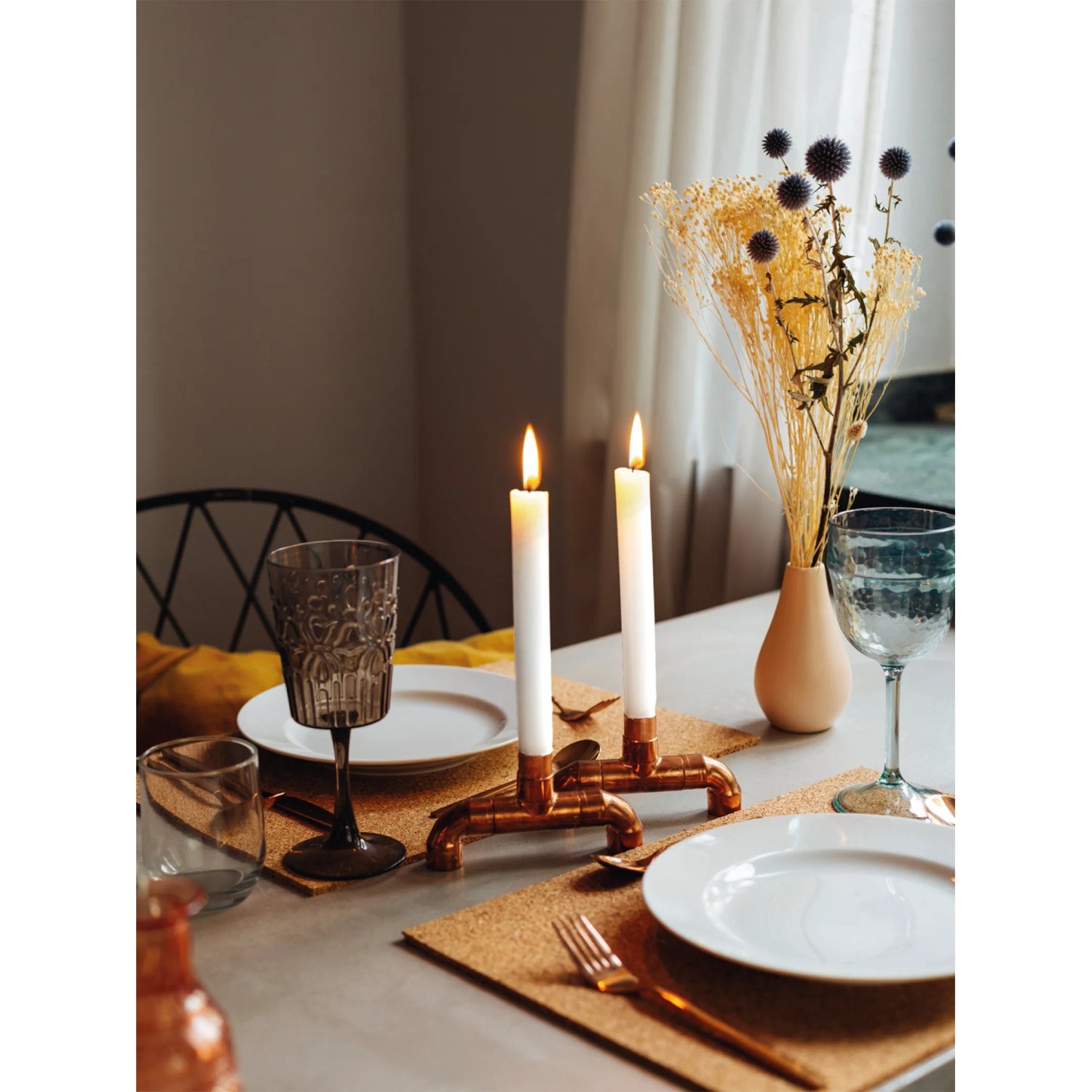 DIY Kerzenständer aus Kupfer von CREATE! by OBI auf gedecktem Tisch mit brennenden Kerzen.