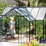 Schwarzes Vitavia Gewächshaus Sirius 13 m² mit ESG-Glas und Fundament im Garten.