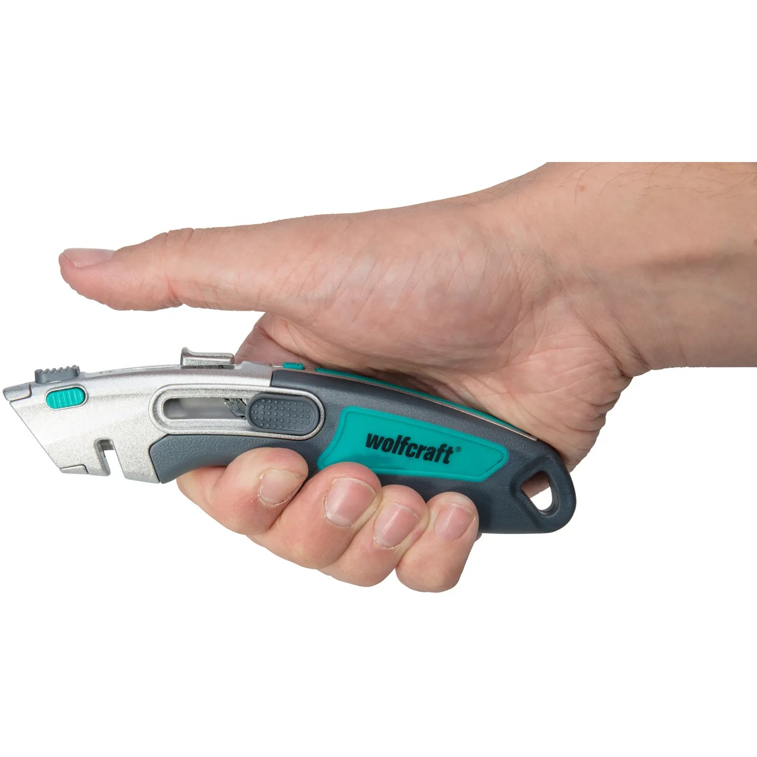 Wolfcraft Profi-Dual-Sicherheitsmesser mit Trapezklinge in Hand, silber/grün.