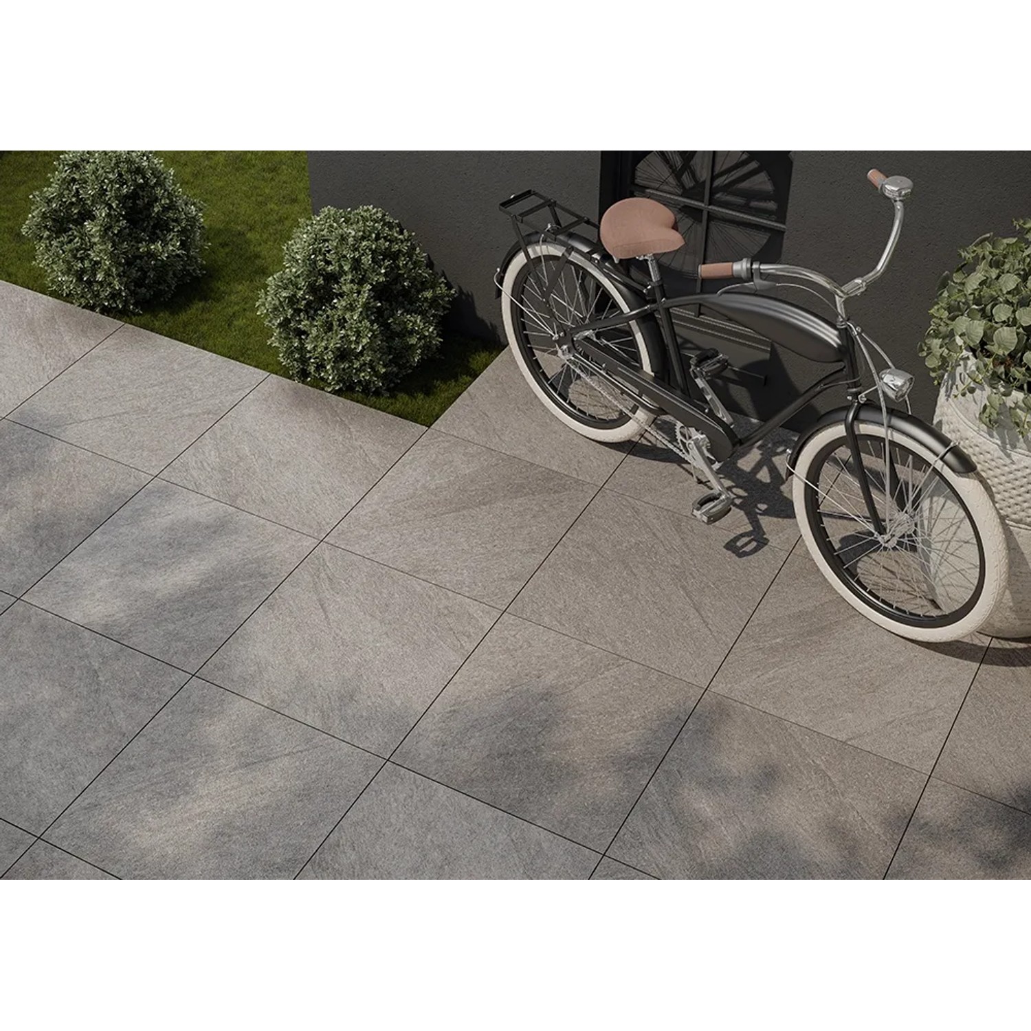Cersanit Bolt Terrassenplatten aus Feinsteinzeug, 59,3x59,3 cm, in Grau verlegt mit Fahrrad.
